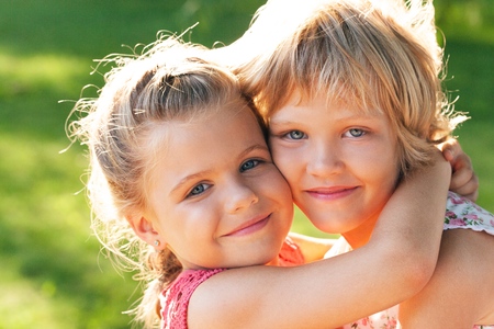 Portrait of Two Little Girlfriends / Sisters Huggingの写真素材