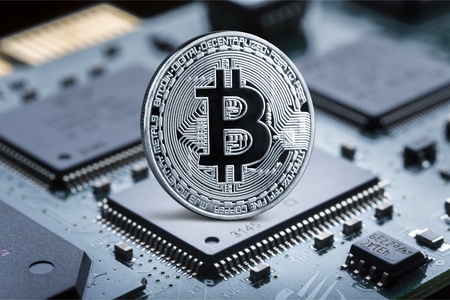 Golden bitcoin on a computer processor