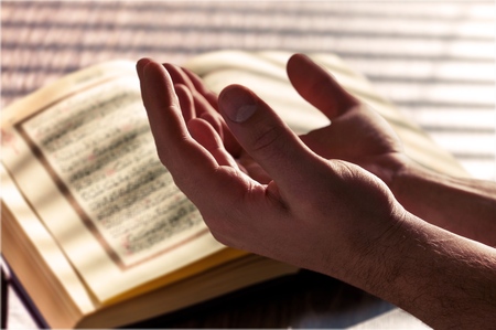 Holy book of Muslims hand