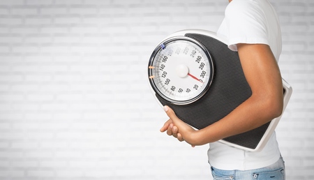 Woman holding a scales