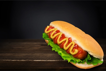 Big hotdog with sausage tomatoes, mustard andの写真素材