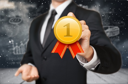 Businessman on blurred background winning the first golden price 3D renderingの写真素材