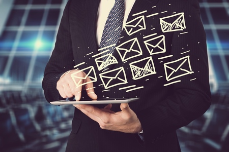 digital tablet in hand and email icon