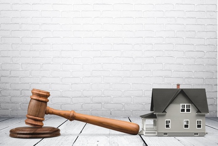 Wooden gavel and model houseの写真素材