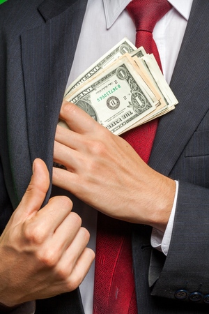Closeup of a Businessman Putting Money in his Pocket