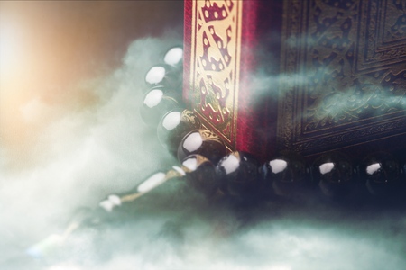 Islamic Book Koran with rosary on greyの写真素材