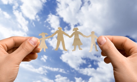 Paper chain family protected in cupped hands