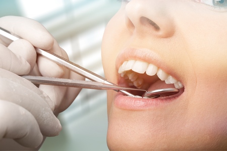 Satisfied dentist patient showing her toothの写真素材