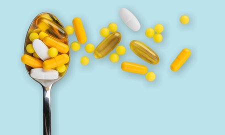 Healthy supplements on steel teaspoons