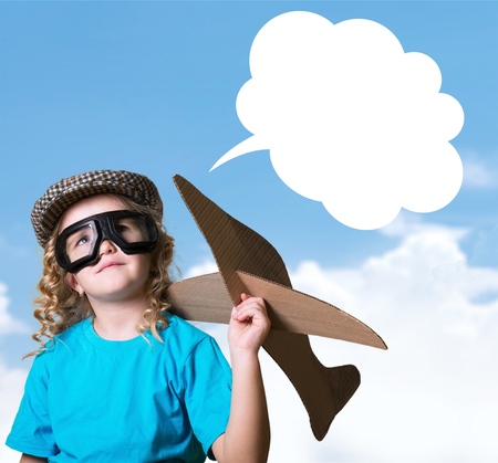 happy child girl playing with toy airplane. the dream of becoming a pilotの写真素材