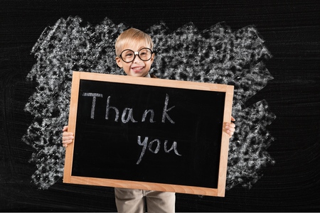 Cute Hispanic Boy Holding Blank Chalkboard Ready for Your Own Message Isolated on a White Background.の写真素材