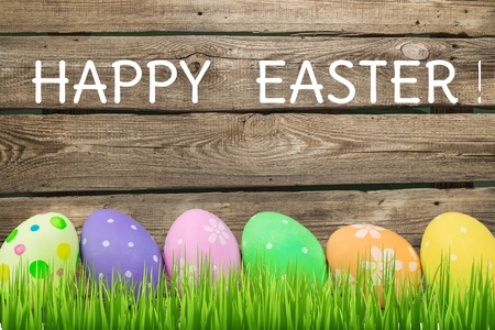 Easter eggs and cute bunny in green grass. Festive decoration. Happy Easter!