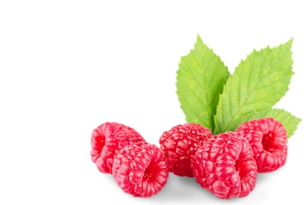 Raspberries with leaves isolated on white background