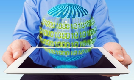 Businessman working on tablet computer - producing charts and reportsの写真素材