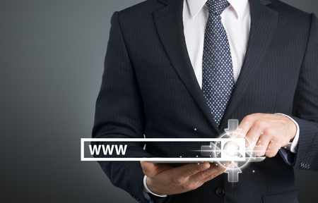 Technology in business : businessman pushing tactile buttonの写真素材