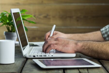 Male hands writing on laptop on backgroundのeditorial素材