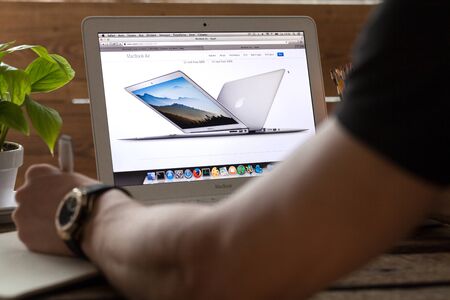 KHERSON, UKRAINE - FEBRUARY 19, 2016: male hands with laptop on backgroundのeditorial素材