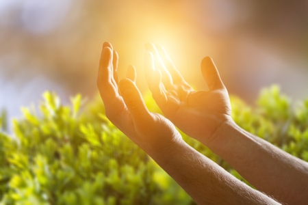 Human hands open palm up worshipの写真素材