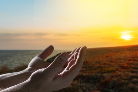 Human hands open palm up worshipの写真素材