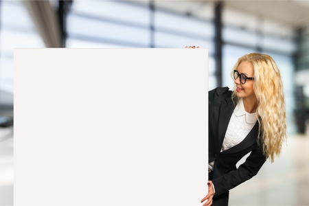 Businesswoman holding a billboardの写真素材