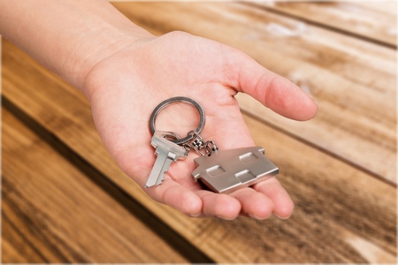 hands holding house keys