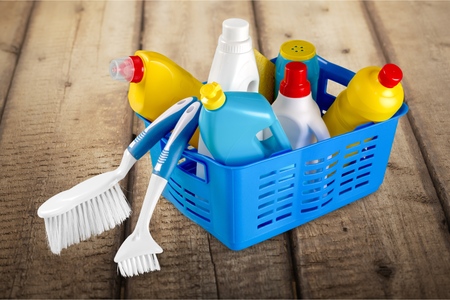 Green and chemical cleaning products together in a bucketの写真素材