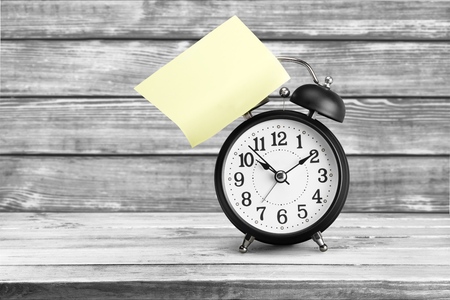 Alarm clock with sticky paper isolated on white background