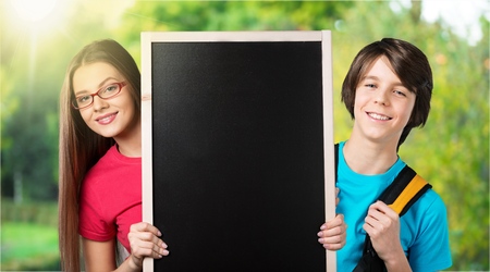 Two adorable little schoolkids feeling very exited about going back to schoolの写真素材