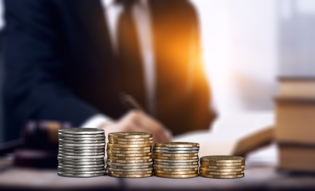 Golden stack money on the deskの写真素材