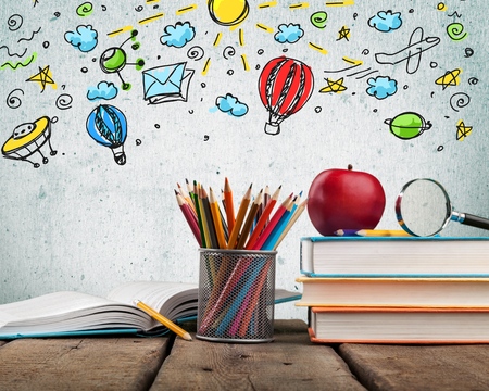 School books ,color pencil ,pen on desk,can creative infographics blackboard inside , the education concept, and gray color backgroundの写真素材