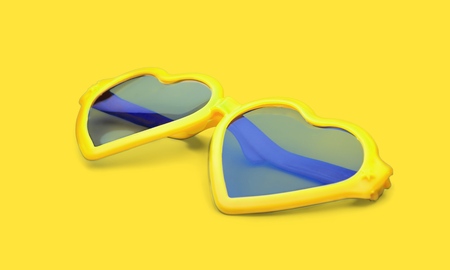 studio shot of yellow sunglasses. summer is coming conceptの写真素材