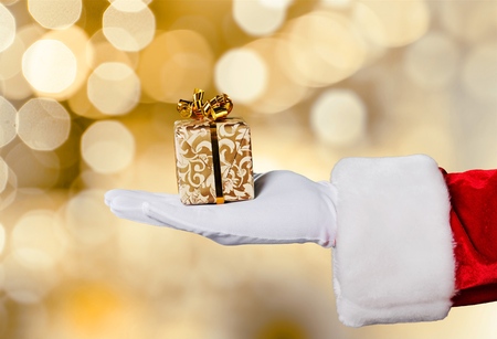Santa Holding Christmas Gift on Red