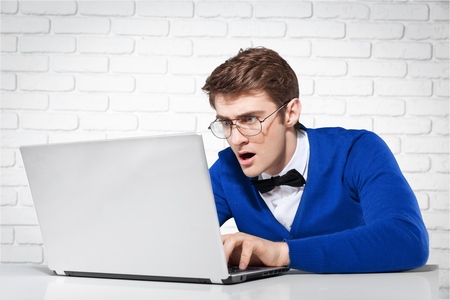 astonished boy working on laptopの写真素材