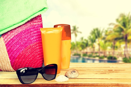 Conceptual summer fun border, beach items isolated on white background, summertime tropical vacation and travel, womens accessories for outdoor relaxation, holidaysの写真素材