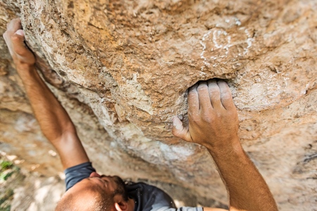 male left hand with chalk powder in cliff climbing sport, Ao Nang, Krabi, Thailandの写真素材