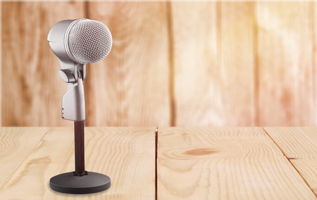 Retro style microphone recorder on deskの写真素材