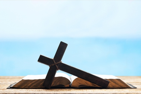 Holy Bible on the background of the Christian cross and the life-giving divine light. The hope of mankind for salvation. The way to God through prayer. The Resurrection and Rapture of Jesus.の写真素材