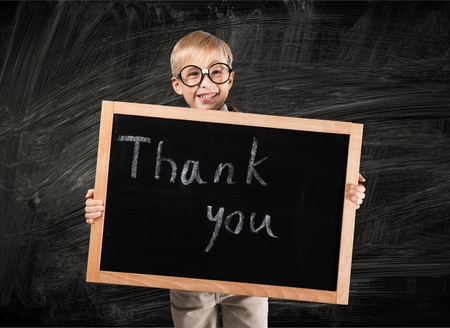 Cute Hispanic Boy Holding Blank Chalkboard Ready for Your Own Message Isolated on a White Background.の写真素材