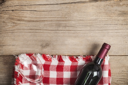 Red wine bottle and corkscrew on white wooden table background with copy spaceの写真素材