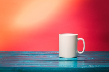 White gravy boat on wooden table over grunge backgroundの写真素材