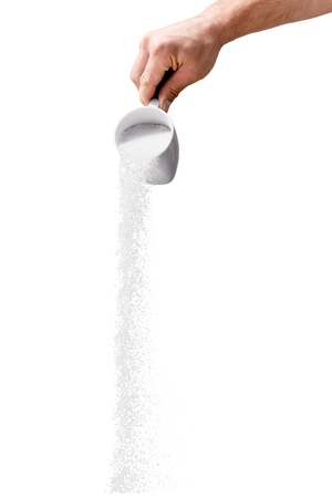 Salt Or Sugar Spilling Out Of The Cupの写真素材