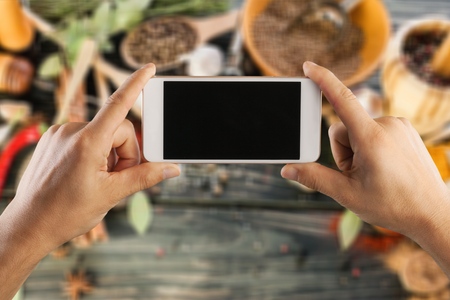 Young woman recording video with foodの写真素材