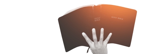 Man praying on holy bible