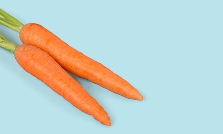 Fresh carrots  on blue backgroundの写真素材