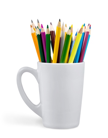 Close up colour pencils in white ceramic cup isolated on white backgroundの写真素材