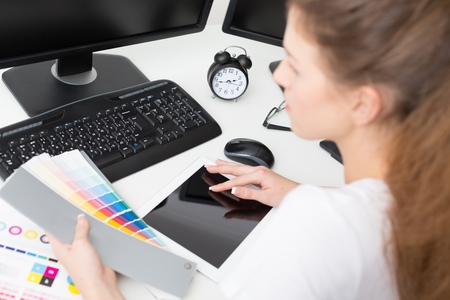 Graphic designer at work. Color swatch samples.