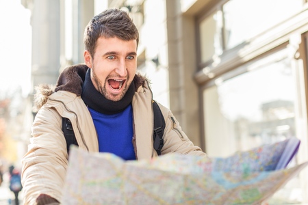 Lost tourist looking at city map on a trip. Looking for directions.