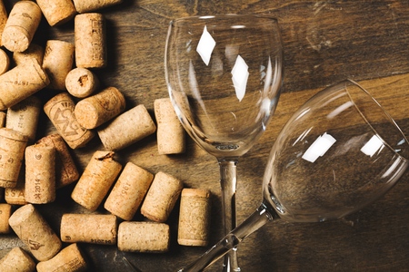 Detail of wine glasses and corks in filtered old vintage style