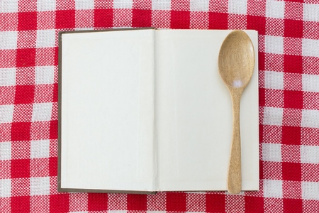 open old recipe book on checkered tableclothの写真素材