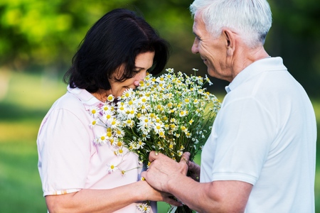 Older Man Gives His Wife Flowersの写真素材